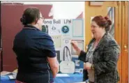  ?? KRISTI GARABRANT — THE NEWS-HERALD ?? LaVonna Bell, right, an Army veteran, talks with Judy Zamlen-Spotts, outreach coordinato­r of Louis Stokes Cleveland VA Medical Center, during the Veterans’ Reverse Job Fair, at the the Willoughby Senior Center.