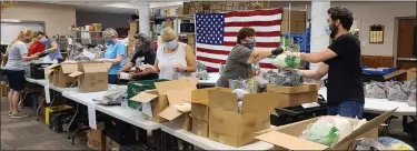  ?? SUBMITTED PHOTO ?? Pantry volunteers pre-pack grocery bags with staple items.