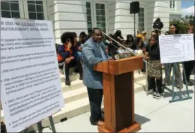  ?? ASHRAF KHALIL — THE ASSOCIATED PRESS ?? Winston Clarke, the father of a Duke Ellington High School junior, speaks during a news conference in front of the school in Washington. Parents at the prestigiou­s performing arts public school are in a fight with the office of the school...