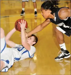  ??  ?? Lookout Valley’s Jamal Jones reaches for the loose ball grabbed by Sale Creek’s Chase Janow on Thursday night. Lookout Valley won 47-41.