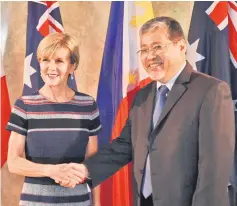  ??  ?? Philippine acting Foreign Affairs Secretary Enrique Manalo (right) shakes hands with Bishop prior to their bilateral meeting at the Foreign Affairs office in Manila. — AFP photo