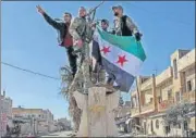  ?? AFP ?? Turkey-backed Syrian fighters celebrate in the town of Saraqib .