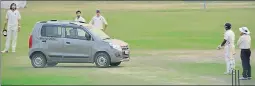  ?? KAMESH SRINIVASAN/THE HINDU ?? Players look on in disbelief as the car is driven onto the cricket pitch.
