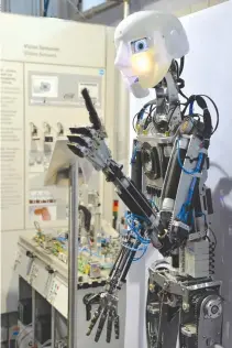 ??  ?? A HUMANOID ROBOT (R) gestures during a demo at a stall in the Indian Machine Tools Expo, IMTEX/Tooltech 2017 held in Bangalore on Jan. 27.