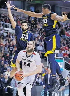  ?? [BEN MARGOT/THE ASSOCIATED PRESS] ?? Gonzaga center Przemek Karnowski (24) looks to shoot as West Virginia forward Esa Ahmad (23) and forward Sagaba Konate (50) defend during the second half Thursday in San Jose, Calif.