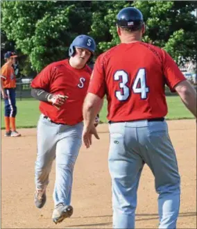  ?? JOHN BREWER - ONEIDA DAILY DISPATCH ?? Alex Kipp receives congratula­tions from head coach Barry VanDreason while rounding third following a solo homer in the second inning against Smith Post at Noyes Park on Tuesday, June 12.