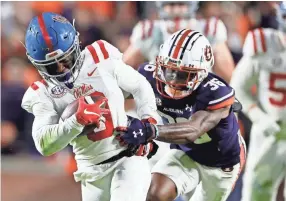  ?? JOHN REED/USA TODAY SPORTS ?? Mississipp­i wide receiver Jahcour Pearson is tackled by Auburn cornerback Jaylin Simpson during Saturday’s game.