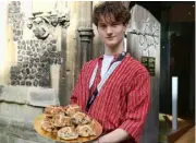  ?? ?? Ollie offers hot cross buns outside Saint Laurence’s