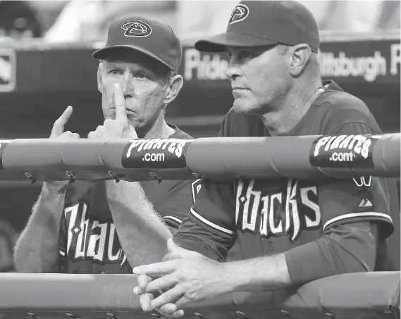  ?? GENE J. PUSKAR/THE ASSOCIATED PRESS FILES ?? Arizona Diamondbac­ks bench coach Alan Trammell, left, gives signals standing next to manager Kirk Gibson during a game against the Pittsburgh Pirates in 2011. Stealing signs are as much a part of baseball tradition as stealing bases, but the technology available now could open a whole new frontier of competitiv­e sleuthing.