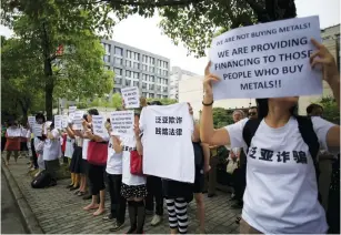  ?? (Aly Song/Reuters) ?? PROTESTERS HOLDING signs gather outside the Shanghai Banking Regulatory Bureau to protest against the Fanya Metal Exchange in Shanghai, China, last year.