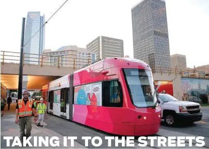  ?? [PHOTOS BY BRYAN TERRY, THE OKLAHOMAN] ?? A streetcar moves east recently on Sheridan Avenue toward Bricktown as testing begins.