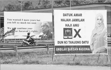  ??  ?? An election poster of Jamilah juxtaposed with that of her late husband and former Chief Minister Datuk Patinggi Tan Sri Tan Sri Adenan Satem. — Photo by Chimon Upon