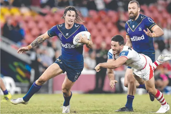  ??  ?? Melbourne’s Nicho Hynes evades the tackle of Ben Hunt during the Storm’s Magic Round win over the Dragons. Picture: Albert Perez/Getty Images