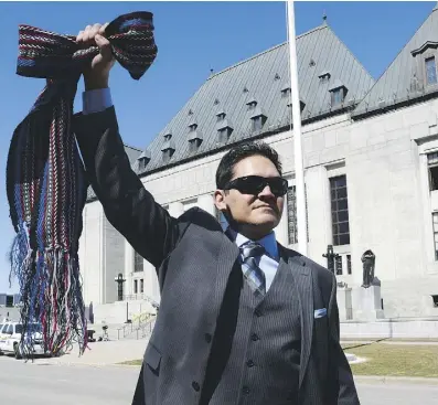  ?? SEAN KILPATRICK/THE CANADIAN PRESS ?? Gabriel Daniels, son of the late Harry Daniels, reacts as he leaves the Supreme Court of Canada in Ottawa on April 14 after the top court’s unanimous ruling that Métis and non-status Indians are, in fact, Indians under the Constituti­on.