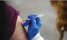  ?? PAUL SANCYA — THE ASSOCIATED PRESS ?? A healthcare worker receives a second Pfizer-BioNTech COVID-19vaccine shot at Beaumont Health in Southfield.