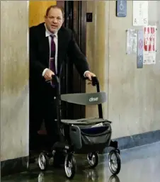  ?? Richard Drew/Associated Press ?? Harvey Weinstein emerges from the elevator Tuesday as he arrives at court for his rape trial in New York City.