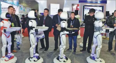  ?? LYU BIN/ FOR CHINA DAILY ?? A team of food-delivery robots is unveiled at the opening of a three-day exhibition in Yiwu, Zhejiang province, on Thursday. The focus of the event was artificial intelligen­ce, green technology and the environmen­t.