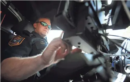  ??  ?? Germantown Police Department Senior Patrol Officer Blake Sternberge­r works the second shift 'city' beat, crossing districts on main thoroughfa­res, covering all of the municipali­ty on May 22, 2019. JOE RONDONE/THE COMMERCIAL APPEAL