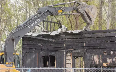  ?? GARY NYLANDER/Special to The Daily Courier ?? An excavator removes metal roof panels from the city-owned Fleming House. Firefighte­rs responded at 3 a.m. Wednesday after flames were spotted coming from the historic old house on April 22.