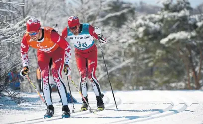  ?? THOMAS LOVELOCK/THE ASSOCIATED PRESS ?? Canada’s Brian McKeever, with guide Graham Nishikawa, won his 13th career Paralympic­s gold medal in Pyeongchan­g on Saturday.