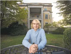  ??  ?? Smith stands in front of the historic Dery mansion in Catasauqua.