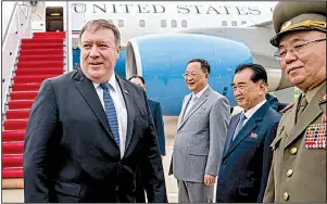  ?? AP/ANDREW HARNIK ?? Secretary of State Mike Pompeo is greeted by North Korean officials Friday as he arrives at the airport in Pyongyang to “fill in some details” on commitment­s made at the Singapore summit.