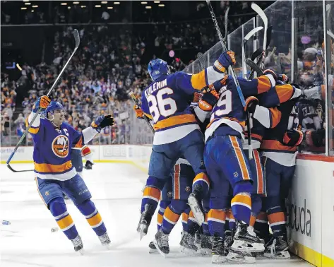  ?? ADAM HUNGER/THE ASSOCIATED PRESS ?? After celebratin­g a Game 3 overtime victory on Sunday night, the New York Islanders hold a surprising 2-1 series lead over the Florida Panthers, which has energized the fans at Brooklyn’s Barclays Center.