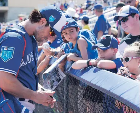  ?? FRANK GUNN/THE CANADIAN PRESS ?? Earlier this spring, Randal Grichuk signs autographs for fans in Dunedin. The Blue Jays are hoping Grichuk will replace some of Jose Bautista’s offence.