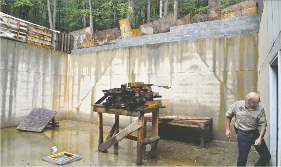  ?? PHOTOS: MICHAEL S. WILLIAMSON/FOR THE WASHINGTON POST ?? Steve Rene exits a bunker that’s under constructi­on at Fortitude Ranch.