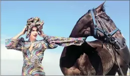  ?? PICTURE: IAN LANDSBERG/AFRICAN NEWS AGENCY (ANA) ?? Miss South Africa, Adé van Heerden, dressed in an Afrofuturi­stic dress by Cape Town designer Mzukisi Mbane from Imprint with Sun Met favourite Somnambuli­sm during the horses spa day at Sunrise Beach in Muizenberg.