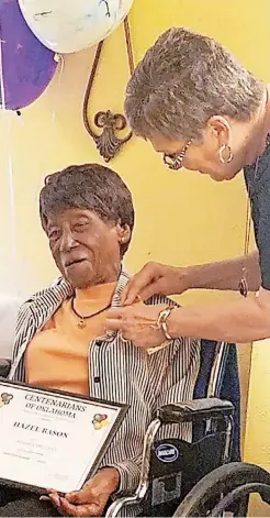  ??  ?? RIGHT: Sue Scott, of the Centenaria­ns of Oklahoma, presents Hazel Bason with a certificat­e, “Golden Okie” pin and angel pin during a celebratio­n to honor Bason.