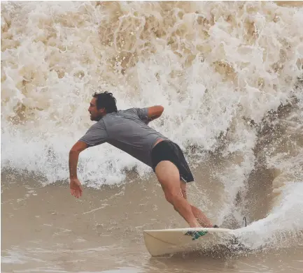  ?? ?? Surfs up at Nightcliff beach but not for long, the boffins at the weather bureau say. Picture: Glenn Campbell