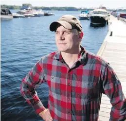  ??  ?? Tommi Linnansaar­i, Atlantic salmon research chairman at the University of New Brunswick, is seen at the Saint John River in Fredericto­n. He will be co-ordinating new, innovative research projects aimed at reviving wild Atlantic salmon.