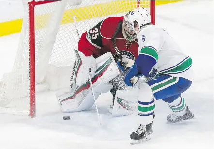  ?? — AP FILES ?? Brock Boeser scores against Wild goalie Darcy Kuemper in his NHL debut with the Canucks in Minnesota last month. Boeser offers hope for a few more goals next season.