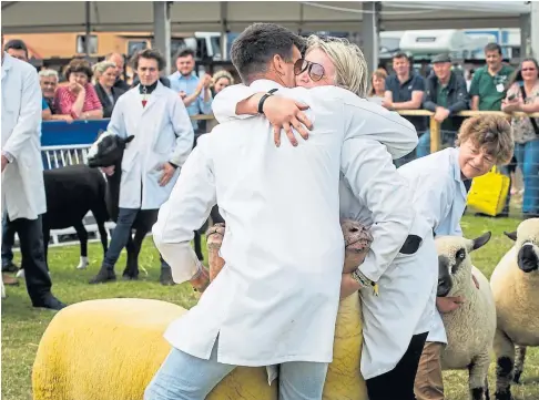  ?? ?? PRIZE GUYS: Pip Kermode and Will Price are overjoyed after their sheep won the pairs competitio­n in 2019.