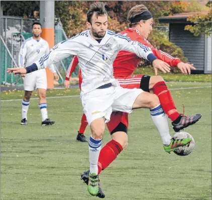  ?? KEITH GOSSE/THE TELEGRAM ?? Alex Laperriere (left) of the Universite de Moncton Aigles Bleus and Tyler Kirby of the Memorial Sea-hawks contend fort the ball during AUS men’s soccer action at King George V field Saturday afternoon. Moncton won 1-0, but the Sea-hawks had already...