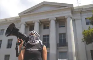  ?? (Justin Sullivan/Getty Images) ?? A PRO-PALESTINIA­N protester uses a bullhorn during a demonstrat­ion on the UC Berkeley campus on Monday.