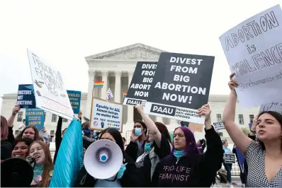  ?? Anna Moneymaker/getty Images/tns ?? ■ Pro-choice and anti-abortion activists demonstrat­e in front of the U.S. Supreme Court Building on Tuesday in Washington, D.C.