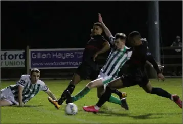  ??  ?? Janabi Amour (nearest camera) stretches to score his first goal for the club, as Kaleem Simon watches.