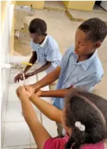  ?? CONTRIBUTE­D PHOTO BY CATHERINE COLBY ?? Dominican Republic children wash their hands at a water station provided by the Chattanoog­a Rotary Club.