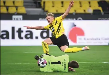  ?? AFP ?? Dortmund’s Norwegian forward Erling Braut Haaland attempts to get the ball past Union Berlin’s German goalkeeper Andreas Luthe during the German first division Bundesliga football match on April 21.