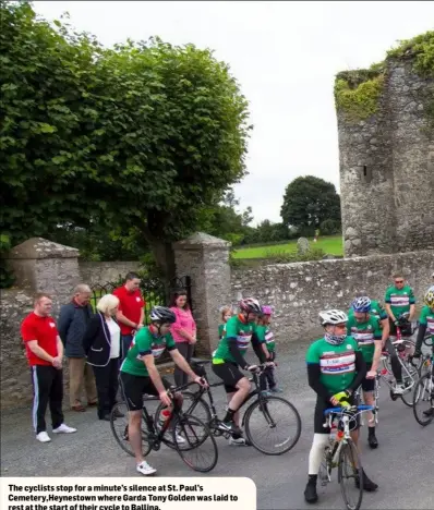  ??  ?? The cyclists stop for a minute’s silence at St. Paul’s Cemetery,Heynestown where Garda Tony Golden was laid to rest at the start of their cycle to Ballina.