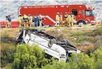  ?? DON BOOMER ?? A charter bus on Interstate 15 heading to San Ysidro rolled down an embankment off Interstate 15 in North County Saturday morning, killing three people and injuring 18 others.