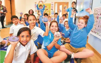  ?? Clint Egbert/Gulf News ?? Kimia Mackay (right) holding ‘Gratitude Stones’ with her Aquila School friends. Students were given small rocks to register their sense of gratitude as part of the new campaign.