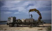  ?? FATIMA SHBAIR – THE ASOCIATED PRESS ?? Palestinia­ns bring cement blocks to a pier that could be used to bring humanitari­an aid to the Gaza Strip in Khan Younis on Wednesday. Some aid has begun to flow in.