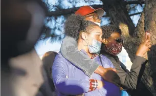  ?? KAITLIN MCKEOWN/STAFF ?? People gather Tuesday for a vigil for Donovon Lynch near the intersecti­on of 20th Street and Pacific Avenue in Virginia Beach. Lynch was fatally shot by a police officer Friday.