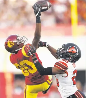  ?? Kelvin Kuo / Associated Press ?? USC’s Deontay Burnett (left), covered by Utah’s Javelin Guidry, is unable to pull in a pass during the first half of the Trojans’ win in Los Angeles.