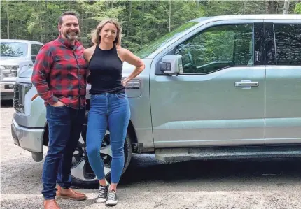 ?? PROVIDED BY NICK SCHMIDT ?? Nick and Alicia Schmidt of Standish, Mich., were the first customers to take possession of the Ford F-150 Lightning in May. The starting price of the all-electric vehicle is $39,974, but packages can add to that base.