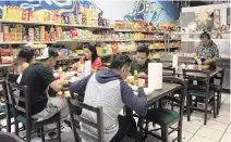  ?? ?? Cruise ship crew members dine at Filipino restaurant Manila Kantina, which is located near PortMiami.