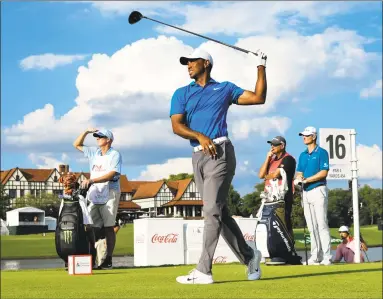  ?? John Amis / Associated Press ?? Tiger Woods hits out of the 16th tee box during the third round of the Tour Championsh­ip on Saturday in Atlanta.